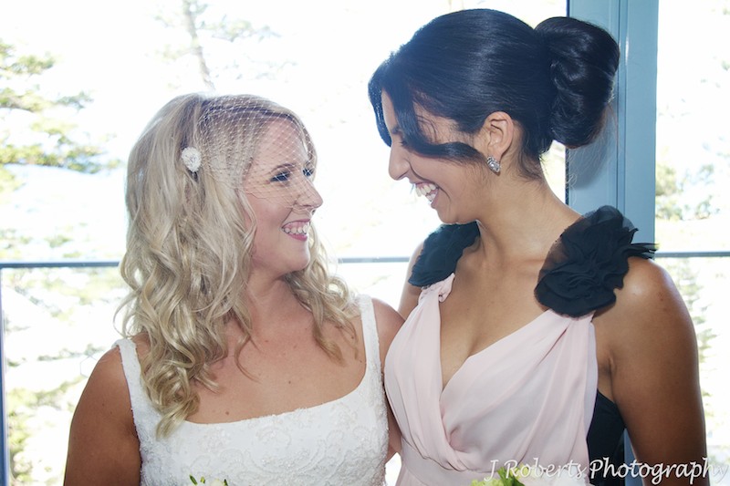 Bride laughing with bridesmaid - wedding photography sydney
